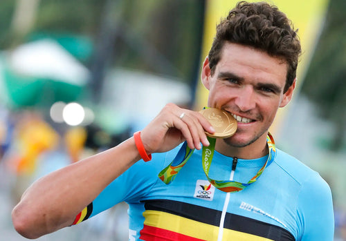 Olympic Champion Greg Van Avermaet is holding his gold medal at the Rio 2016 Olympic Games