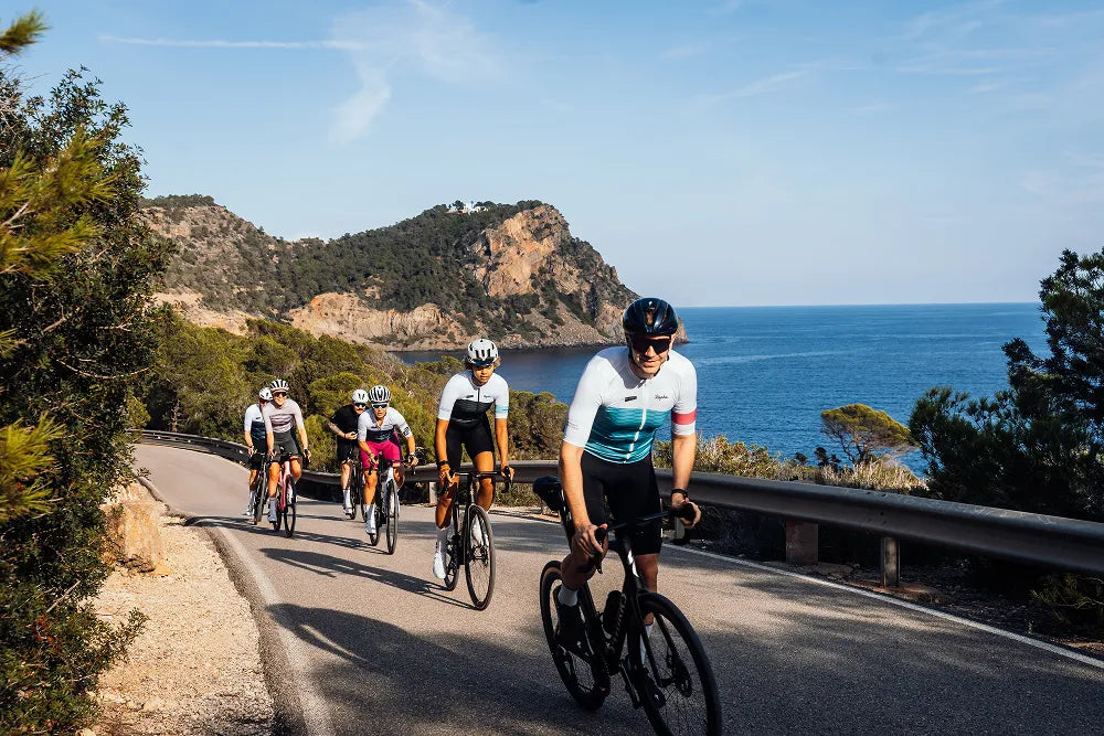 Cyclists riding through sun-drenched Ibiza on a LeBlanq luxury cycling experience